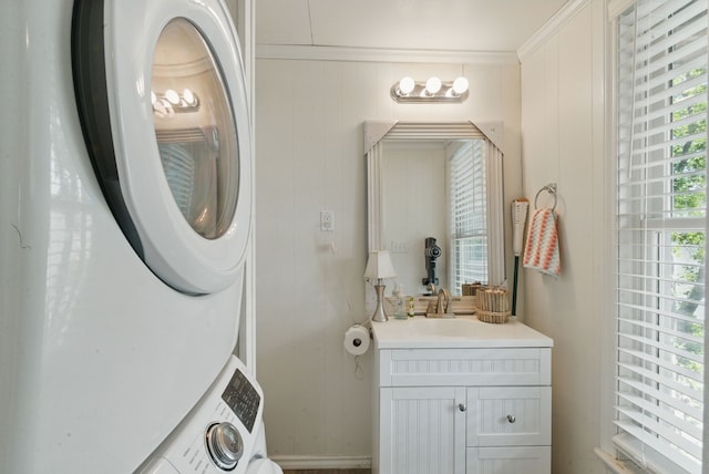 306 Chism Trl, Gordon, TX 76453 - clothes washing area with stacked washer and clothes dryer and crown molding