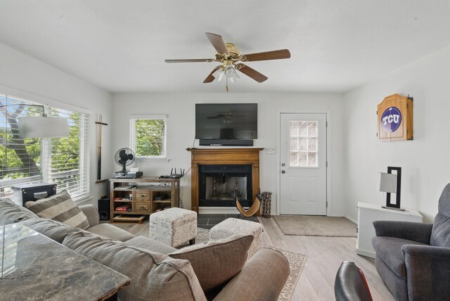306 Chism Trl, Gordon, TX 76453 - living room with a fireplace, a ceiling fan, wood finished floors, and baseboards