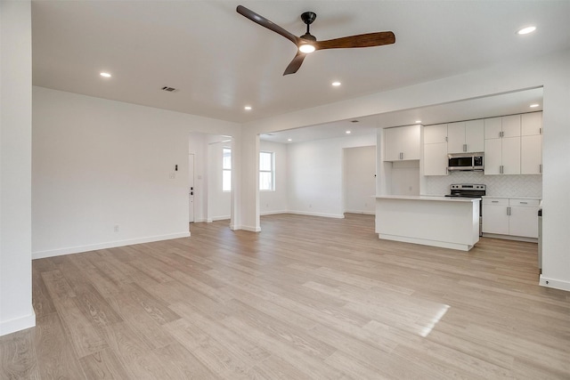 171 Tryall Ct, Runaway Bay, TX 76426 - unfurnished living room with ceiling fan, light wood finished floors, baseboards, and recessed lighting
