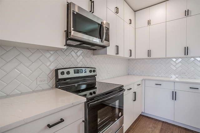 171 Tryall Ct, Runaway Bay, TX 76426 - kitchen featuring stainless steel appliances, light stone countertops, tasteful backsplash, and white cabinets
