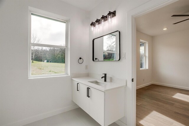 171 Tryall Ct, Runaway Bay, TX 76426 - bathroom with baseboards, a ceiling fan, and vanity
