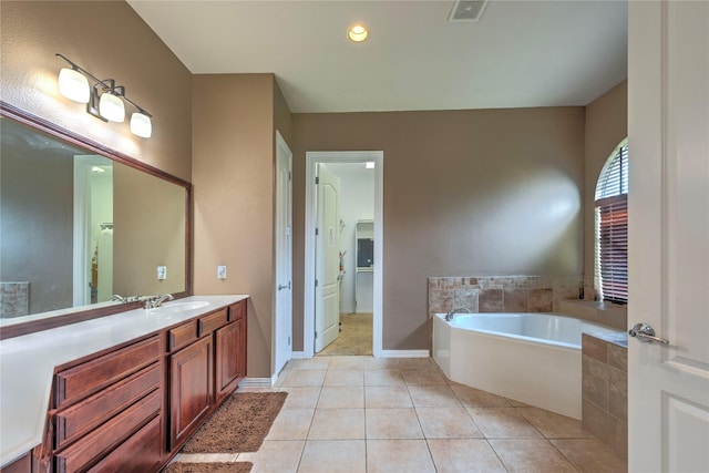 319 Paloverde Ln, Frisco, TX 75036 - bathroom featuring a garden tub, tile patterned floors, vanity, and baseboards