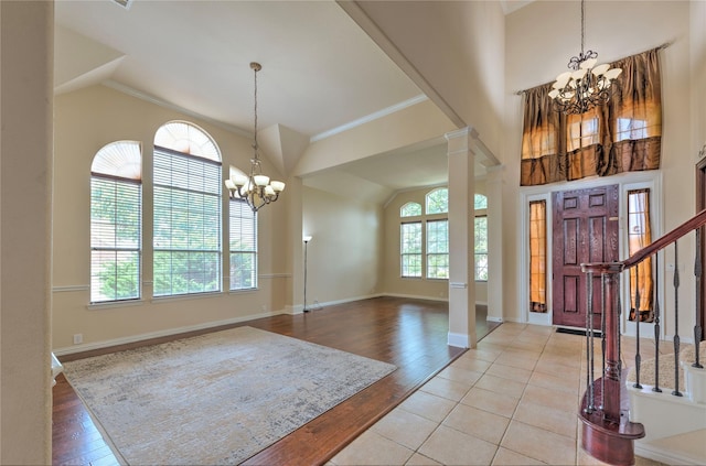 319 Paloverde Ln, Frisco, TX 75036 - foyer entrance with a chandelier, ornamental molding, light wood-type flooring, baseboards, and ornate columns