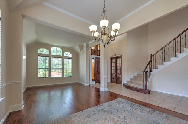 319 Paloverde Ln, Frisco, TX 75036 - entrance foyer featuring a chandelier, vaulted ceiling, hardwood / wood-style floors, stairs, and baseboards