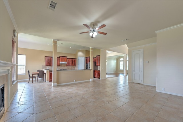 319 Paloverde Ln, Frisco, TX 75036 - unfurnished living room with a fireplace, ceiling fan, decorative columns, baseboards, and plenty of natural light