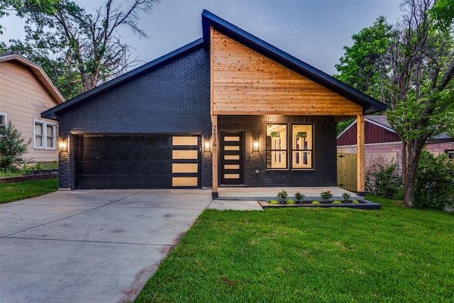 2614 Ave G, Fort Worth, TX 76105 - view of front of house featuring brick siding, concrete driveway, and a garage