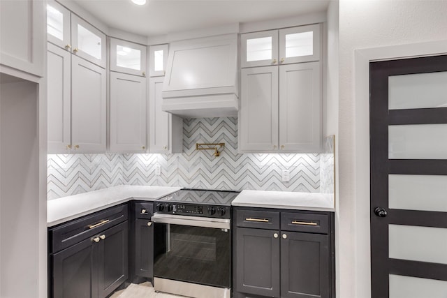 2614 Ave G, Fort Worth, TX 76105 - kitchen featuring range with electric cooktop, white cabinets, light countertops, and backsplash