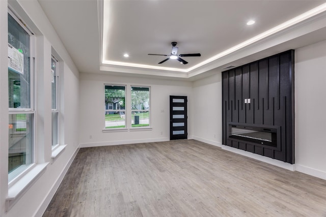 2614 Ave G, Fort Worth, TX 76105 - unfurnished living room featuring wood finished floors, ceiling fan, a raised ceiling, baseboards, and recessed lighting