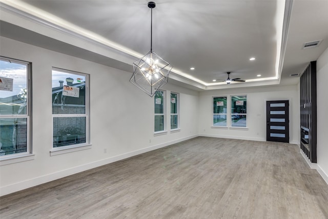 2614 Ave G, Fort Worth, TX 76105 - unfurnished living room featuring a raised ceiling, light wood-style flooring, recessed lighting, baseboards, and a chandelier
