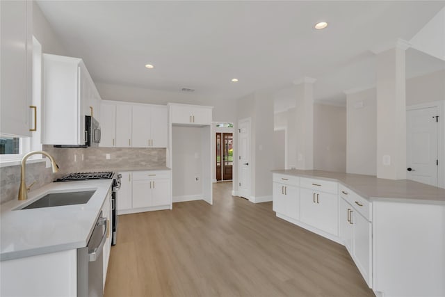 1529 Harvest Run Dr, Allen, TX 75002 - kitchen with a sink, light wood finished floors, backsplash, stainless steel appliances, and recessed lighting