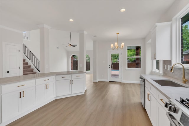 1529 Harvest Run Dr, Allen, TX 75002 - kitchen with appliances with stainless steel finishes, a sink, light wood-style floors, a chandelier, and light countertops