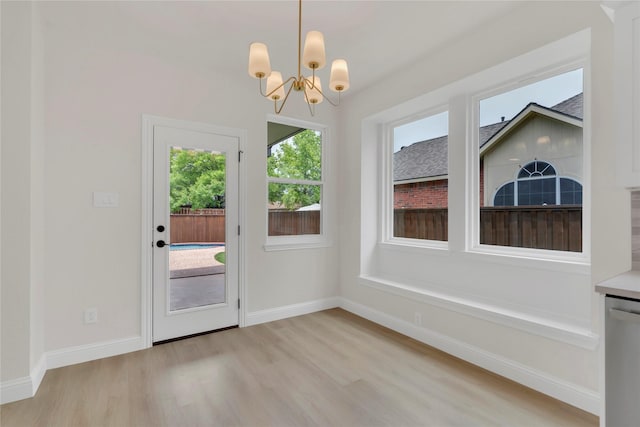 1529 Harvest Run Dr, Allen, TX 75002 - unfurnished dining area featuring light wood-style floors, a chandelier, and baseboards