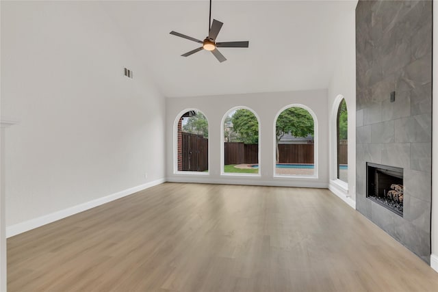 1529 Harvest Run Dr, Allen, TX 75002 - unfurnished living room featuring high vaulted ceiling, ceiling fan, a fireplace, light wood finished floors, and baseboards