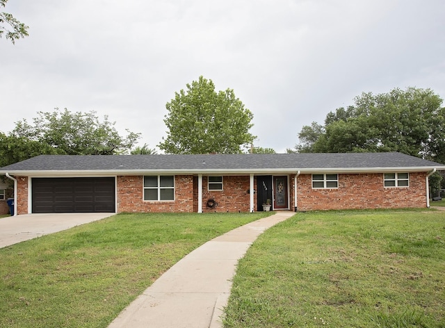 1413 Oak Hills Dr, Graham, TX 76450 - single story home featuring a garage, a front lawn, concrete driveway, and brick siding