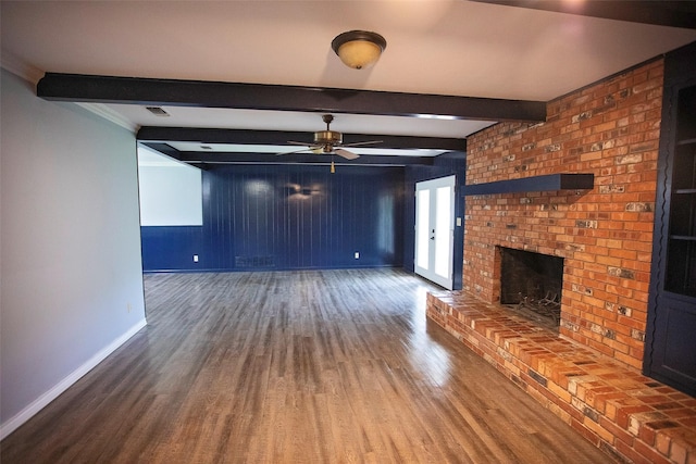 1413 Oak Hills Dr, Graham, TX 76450 - unfurnished living room featuring a fireplace, wood finished floors, baseboards, a ceiling fan, and beamed ceiling