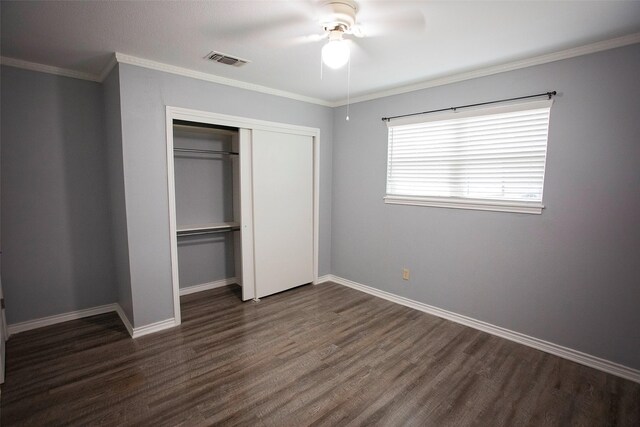 1413 Oak Hills Dr, Graham, TX 76450 - unfurnished bedroom featuring dark wood-style floors, a closet, baseboards, a ceiling fan, and ornamental molding