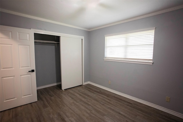 1413 Oak Hills Dr, Graham, TX 76450 - unfurnished bedroom with dark wood-style floors, baseboards, a closet, and crown molding