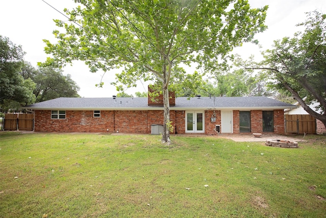 1413 Oak Hills Dr, Graham, TX 76450 - back of house featuring french doors, an outdoor fire pit, and brick siding