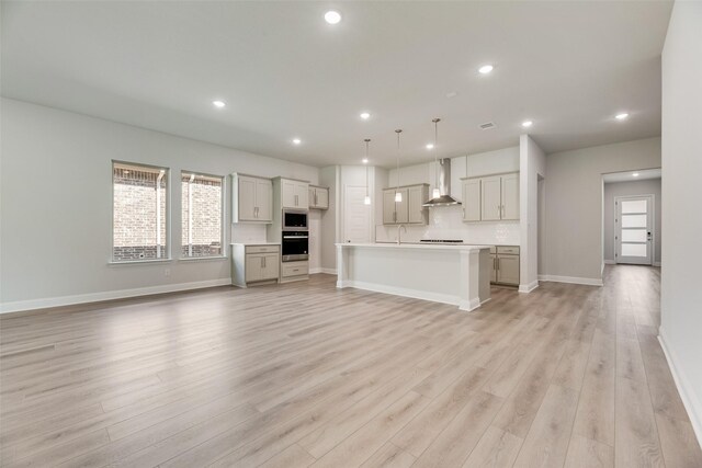 7111 Manhattan Dr, Rowlett, TX 75088 - unfurnished living room with light wood-style floors, baseboards, recessed lighting, and a sink
