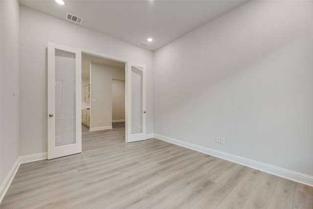 7111 Manhattan Dr, Rowlett, TX 75088 - empty room with light wood finished floors, baseboards, french doors, and recessed lighting