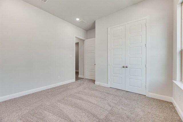 7111 Manhattan Dr, Rowlett, TX 75088 - unfurnished bedroom featuring carpet floors, a closet, and baseboards