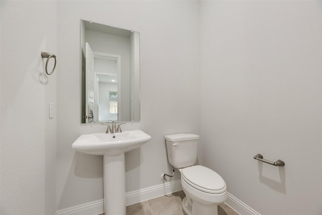 7111 Manhattan Dr, Rowlett, TX 75088 - half bath with baseboards, toilet, a sink, and tile patterned flooring