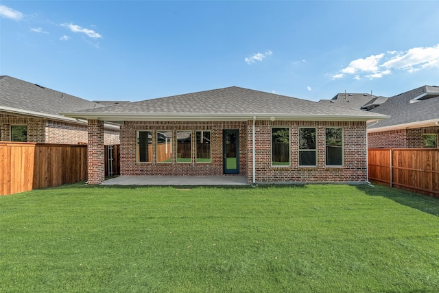 7111 Manhattan Dr, Rowlett, TX 75088 - rear view of property featuring brick siding, a patio area, and a shingled roof