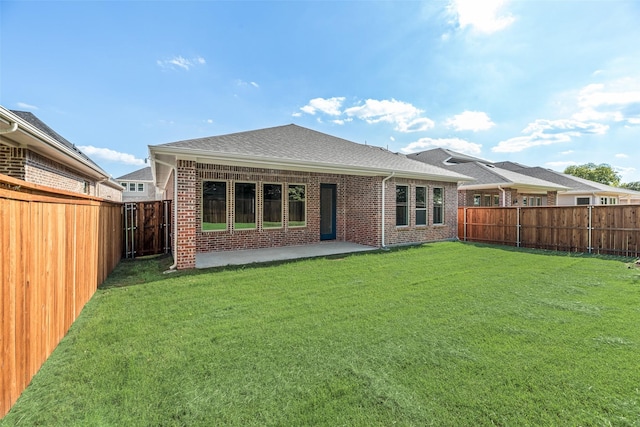 7111 Manhattan Dr, Rowlett, TX 75088 - back of house featuring brick siding, roof with shingles, and a patio area