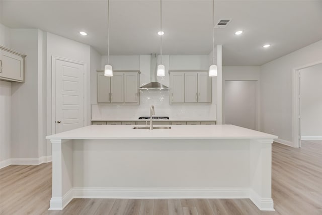 7111 Manhattan Dr, Rowlett, TX 75088 - kitchen featuring wall chimney range hood, light wood-style flooring, backsplash, light countertops, and recessed lighting