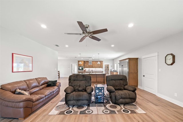 12570 County Road 313, Tyler, TX 75708 - living room featuring light wood finished floors, a ceiling fan, recessed lighting, and baseboards