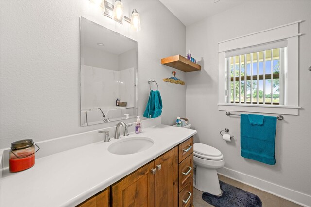 12570 County Road 313, Tyler, TX 75708 - bathroom featuring toilet, a shower, vanity, and baseboards