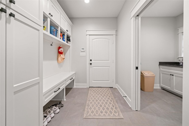 12570 County Road 313, Tyler, TX 75708 - mudroom with light tile patterned floors, recessed lighting, a sink, and baseboards