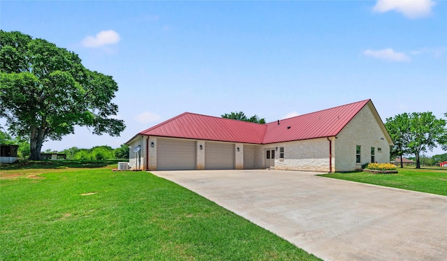 12570 County Road 313, Tyler, TX 75708 - view of front of home featuring stone siding, a garage, metal roof, driveway, and a front yard