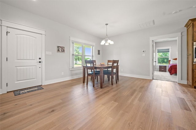 12570 County Road 313, Tyler, TX 75708 - dining room featuring a chandelier, light wood-style flooring, and baseboards
