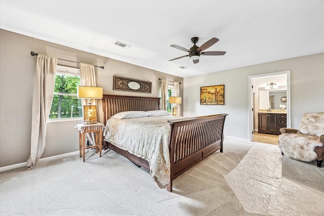 635 Old Justin Rd, Argyle, TX 76226 - bedroom with baseboards, light carpet, ceiling fan, and connected bathroom