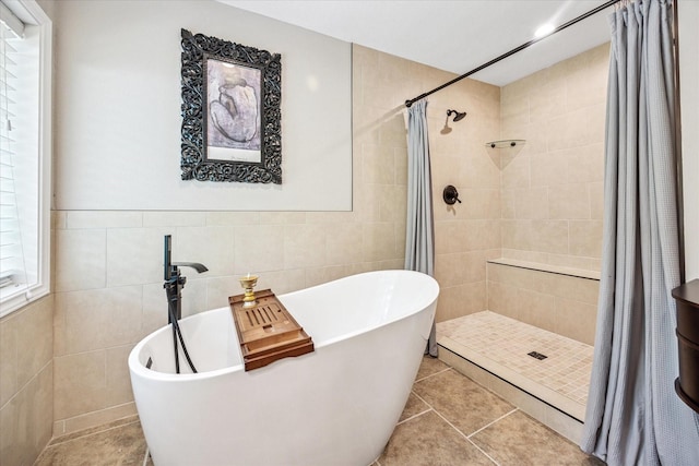 635 Old Justin Rd, Argyle, TX 76226 - bathroom with tile walls, a tile shower, a freestanding bath, and tile patterned floors