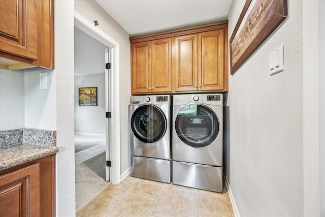635 Old Justin Rd, Argyle, TX 76226 - washroom with cabinet space, washing machine and clothes dryer, light tile patterned floors, and baseboards