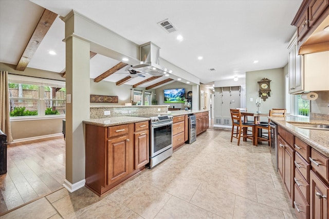 635 Old Justin Rd, Argyle, TX 76226 - kitchen featuring appliances with stainless steel finishes, brown cabinets, light stone counters, baseboards, and recessed lighting