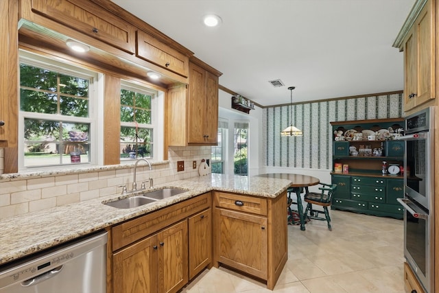 4401 Longacres Ct, Arlington, TX 76016 - kitchen featuring appliances with stainless steel finishes, a sink, wallpapered walls, pendant lighting, and backsplash