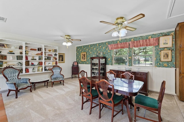4401 Longacres Ct, Arlington, TX 76016 - carpeted dining space featuring ceiling fan, ornamental molding, wallpapered walls, and a wainscoted wall