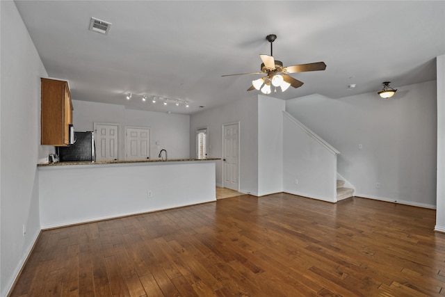 5719 Butterfly Way, Fairview, TX 75069 - unfurnished living room with stairway, a ceiling fan, and hardwood / wood-style floors