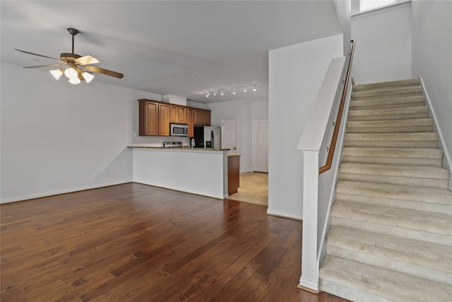 5719 Butterfly Way, Fairview, TX 75069 - unfurnished living room with stairway, a ceiling fan, dark wood-style flooring, and rail lighting