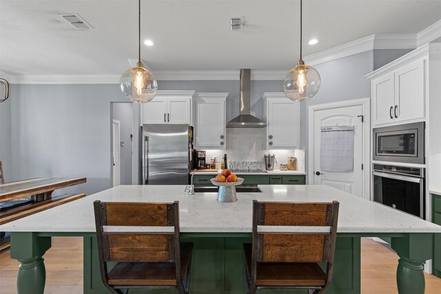 101 Cedar Mountain Dr, Weatherford, TX 76085 - kitchen with wall chimney exhaust hood, stainless steel appliances, white cabinets, ornamental molding, and a breakfast bar