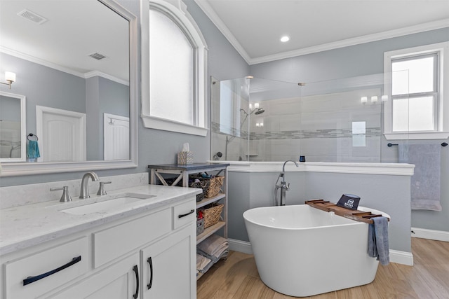 101 Cedar Mountain Dr, Weatherford, TX 76085 - full bathroom featuring vanity, a freestanding bath, a walk in shower, wood finished floors, and ornamental molding