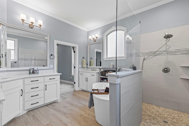 101 Cedar Mountain Dr, Weatherford, TX 76085 - full bath with walk in shower, two vanities, a soaking tub, ornamental molding, and wood finished floors