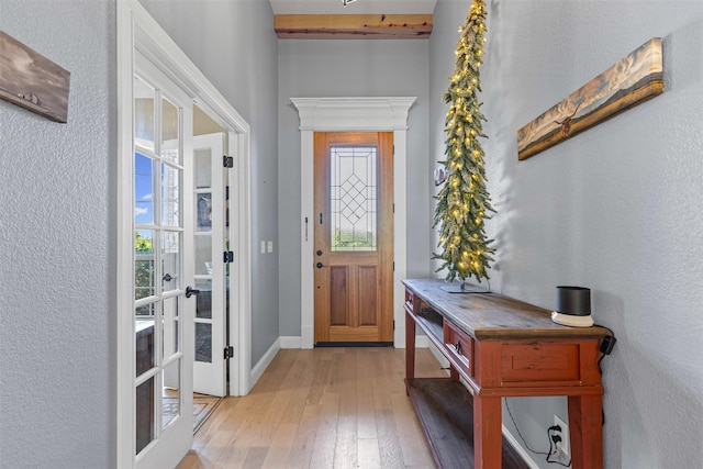 101 Cedar Mountain Dr, Weatherford, TX 76085 - foyer entrance with french doors, light wood-style floors, a textured wall, and baseboards