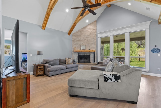 101 Cedar Mountain Dr, Weatherford, TX 76085 - living area featuring high vaulted ceiling, baseboards, a ceiling fan, a stone fireplace, and light wood-style floors