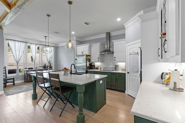 101 Cedar Mountain Dr, Weatherford, TX 76085 - kitchen with wall chimney range hood, green cabinetry, stainless steel refrigerator, a sink, and ornamental molding
