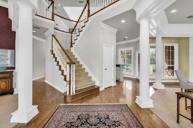 5503 Arch Bridge Ct, Arlington, TX 76017 - entryway with decorative columns, crown molding, wood finished floors, baseboards, and stairs