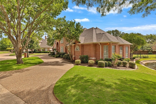 5503 Arch Bridge Ct, Arlington, TX 76017 - view of front of property featuring brick siding, a front lawn, and roof with shingles